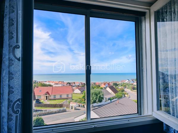 Dans un cadre privilégié à Équihen-Plage, venez découvrir cette jolie maison bel étage semi-individuelle de 108 m² habitables, située sur une parcelle de 405 m² et offrant une vue mer exceptionnelle depuis chaque niveau.
Le premier étage constitue l’espace de vie, avec une entrée disposant d’un espace vestiaire, un séjour profitant d’une magnifique vue mer à 180°, une cuisine équipée et un balcon d’environ 4 m² pour profiter pleinement du panorama. Un WC indépendant complète ce niveau.
Au deuxième étage, vous trouverez trois chambres, là encore avec une belle vue sur la mer, ainsi qu’une salle de bains. 
Le rez-de-chaussée est consacré aux espaces annexes avec un garage, une buanderie, un cellier ainsi qu’une seconde cuisine équipée. Cette dernière profite elle aussi d’une belle vue sur la mer et pourrait facilement être repensée selon vos envies.
Un grenier vient compléter l’ensemble et offre un espace de rangement ou un potentiel d’aménagement supplémentaire.
À l’extérieur, la maison dispose d’un grand jardin, d’une dépendance et de plusieurs places de stationnement.
Une maison à rénover, mais qui offre un potentiel rare grâce à ses beaux volumes et surtout à cette vue mer omniprésente et exceptionnelle. Un bien idéal pour ceux qui souhaitent créer une maison à leur image dans un environnement privilégié.