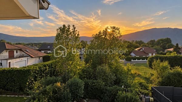 À Valleiry, dans un environnement résidentiel, profitez d’un cadre de vie familial, calme et pratique, à proximité de Genève.

UNE MAISON PENSÉE POUR LA VIE DE FAMILLE
Construite en 2004, cette maison de 7 pièces offre de beaux volumes et une organisation idéale pour une vie de famille confortable.
Répartie sur trois niveaux, elle propose 4 chambres, 2 salles de bains, 3 WC, un garage attenant, deux places de stationnement et un jardin clos.
Implantée sur une parcelle d’environ 274 m², au sein d’un lotissement résidentiel calme, la maison est mitoyenne par un seul côté, au niveau du garage et de la chambre située au-dessus, tout en conservant une réelle indépendance dans ses espaces de vie.
Elle bénéficie d’une situation préservée, sans accès direct sur la route et à l’écart des nuisances sonores.

LE COUP DE CŒUR : UNE VÉRANDA CHAUFFÉE DE 20 M²
Baignée de lumière et largement ouverte sur le jardin, la véranda prolonge agréablement les espaces de vie et crée une atmosphère chaleureuse en toute saison.
Salle à manger conviviale, salon détente, salle de jeux, coin lecture ou espace pour recevoir : chacun pourra imaginer cette pièce selon son mode de vie.

REZ-DE-JARDIN : DES ESPACES FLUIDES ET LUMINEUX
Le rez-de-jardin offre une distribution agréable et fonctionnelle.
L’entrée ouvre sur une belle pièce de vie lumineuse d’environ 36 m², composée d’un séjour et d’une cuisine ouverte, avec un premier WC indépendant.
La pièce de vie se prolonge naturellement vers la véranda ouverte sur le jardin.
Le garage attenant, accessible également depuis la véranda, apporte un espace pratique supplémentaire au quotidien.

PREMIER ÉTAGE : MEZZANINE, 2 CHAMBRES ET SUITE PARENTALE
Une spacieuse mezzanine d’environ 16 m² offre un espace polyvalent, idéal pour aménager un bureau, un coin lecture, une salle de jeux ou un espace TV.
Ce niveau comprend également deux chambres, dont une chambre parentale avec salle de bains privative, ainsi qu’un deuxième WC.

DEUXIÈME ÉTAGE : 2 CHAMBRES SUPPLÉMENTAIRES
Le dernier niveau accueille deux autres chambres, des rangements, une seconde salle de bains et un troisième WC, offrant à chacun son propre espace.

CONFORT ET CHAUFFAGE
Le chauffage principal est assuré par un poêle à granulés, relayé si besoin par des convecteurs électriques.

SECTEUR ET COMMODITÉS
La situation est idéale pour concilier vie de famille, quotidien pratique et déplacements vers le bassin genevois.
La douane de Chancy permet de rejoindre rapidement Genève et constitue un véritable atout pour les actifs frontaliers souhaitant profiter d’un cadre résidentiel calme tout en restant proches de leur lieu de travail.
Pour les familles, le groupe scolaire Les Primevères, de la maternelle au CM2, est accessible à pied, tandis que le Collège du Vuache à Vulbens se situe à environ 10 minutes, avec des transports scolaires au départ de Valleiry.
Au quotidien, tout est à portée de main : supermarché, boulangeries, pharmacie, professionnels de santé, banques, bureau de poste, restaurants et gare SNCF.

À DÉCOUVRIR
Un bien familial complet, fonctionnel et idéalement situé, qui conjugue espace, calme, praticité et proximité de Genève.