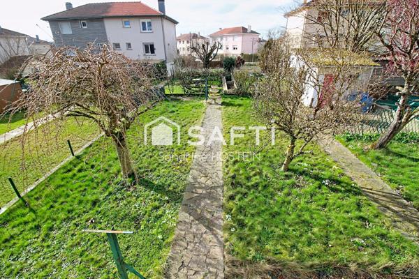 Maison jumelée de 100m2 hab avec grand garage, terrasse et jardin.