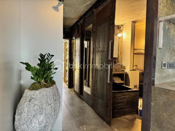 75 m2 pour cet incroyable univers à vivre, il revendique une esthétique résolument brutaliste. Situé au 1er étage avec ascenseur, il est distribué comme suit, un appartement de 54 m² Carrez avec 2 chambres, balcon de 2 m²(pondéré à 1m2) et son jardin japonais de 60 m² (pondéré à 20m2).
Le vaste séjour de 25 m² s’ouvre sur un magnifique jardin japonais privatif orienté à l’est, offrant un cadre de vie rare et apaisant.
L’appartement comprend une suite avec baignoire, une seconde chambre bénéficiant de son propre balcon, un dressing ainsi qu’une salle d’eau avec WC.Chaque matériau a été soigneusement sélectionné pour composer un univers architectural unique. Le béton vibré des murs dialogue avec le quartzite oxydé du plan de travail, le schiste noir des salles d’eau et les finitions en aluminium anodisé.

Une grande place de parking en sous-sol complète ce bien.

Véritable œuvre de design habitable, cet appartement a été entièrement pensé et aménagé par son propriétaire actuel. L’ensemble du mobilier, des équipements et des éléments décoratifs est inclus dans la vente : vous n’aurez qu’à poser vos valises.

Le parc des Buttes-Chaumont et le Rosa Bonheur sont accessibles à pied. Vous profiterez également de la proximité immédiate d’un marché, de nombreux commerces et de toutes les commodités du quartier.


Located on the first floor of a building with elevator access, this remarkable living space offers 75 sqm of weighted area, boldly combining a brutalist and contemporary aesthetic with the serenity of a 60 sqm Japanese garden (weighted at 20 sqm). The property comprises a 54 sqm Carrez-law apartment extended by a 2 sqm balcony (weighted at 1 sqm), creating a distinctive and inspiring living environment. Every material has been carefully selected to create a unique architectural environment. The vibrated concrete walls interact harmoniously with the oxidized quartzite countertop, the black slate used in the bathrooms, and the anodized aluminum finishes.

The spacious 25 sqm living room opens onto a magnificent private Japanese garden facing east, offering a rare and peaceful living environment. The apartment includes a primary suite with a bathtub, a second bedroom with its own private balcony, a walk-in dressing room, and a shower room with a toilet.

A large underground parking space completes the property.

A true piece of livable design, this apartment was entirely conceived and fitted out by its current owner. All furniture, equipment, and decorative elements are included in the sale—you only need to bring your suitcases.

The Buttes-Chaumont Park and Rosa Bonheur are within walking distance, and you will also benefit from the immediate proximity of a local market, numerous shops, and all the amenities the neighborhood has to offer.