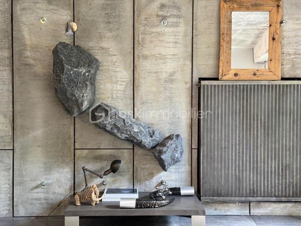75 m2 pour cet incroyable univers à vivre, il revendique une esthétique résolument brutaliste. Situé au 1er étage avec ascenseur, il est distribué comme suit, un appartement de 54 m² Carrez avec 2 chambres, balcon de 2 m²(pondéré à 1m2) et son jardin japonais de 60 m² (pondéré à 20m2).
Le vaste séjour de 25 m² s’ouvre sur un magnifique jardin japonais privatif orienté à l’est, offrant un cadre de vie rare et apaisant.
L’appartement comprend une suite avec baignoire, une seconde chambre bénéficiant de son propre balcon, un dressing ainsi qu’une salle d’eau avec WC.Chaque matériau a été soigneusement sélectionné pour composer un univers architectural unique. Le béton vibré des murs dialogue avec le quartzite oxydé du plan de travail, le schiste noir des salles d’eau et les finitions en aluminium anodisé.

Une grande place de parking en sous-sol complète ce bien.

Véritable œuvre de design habitable, cet appartement a été entièrement pensé et aménagé par son propriétaire actuel. L’ensemble du mobilier, des équipements et des éléments décoratifs est inclus dans la vente : vous n’aurez qu’à poser vos valises.

Le parc des Buttes-Chaumont et le Rosa Bonheur sont accessibles à pied. Vous profiterez également de la proximité immédiate d’un marché, de nombreux commerces et de toutes les commodités du quartier.


Located on the first floor of a building with elevator access, this remarkable living space offers 75 sqm of weighted area, boldly combining a brutalist and contemporary aesthetic with the serenity of a 60 sqm Japanese garden (weighted at 20 sqm). The property comprises a 54 sqm Carrez-law apartment extended by a 2 sqm balcony (weighted at 1 sqm), creating a distinctive and inspiring living environment. Every material has been carefully selected to create a unique architectural environment. The vibrated concrete walls interact harmoniously with the oxidized quartzite countertop, the black slate used in the bathrooms, and the anodized aluminum finishes.

The spacious 25 sqm living room opens onto a magnificent private Japanese garden facing east, offering a rare and peaceful living environment. The apartment includes a primary suite with a bathtub, a second bedroom with its own private balcony, a walk-in dressing room, and a shower room with a toilet.

A large underground parking space completes the property.

A true piece of livable design, this apartment was entirely conceived and fitted out by its current owner. All furniture, equipment, and decorative elements are included in the sale—you only need to bring your suitcases.

The Buttes-Chaumont Park and Rosa Bonheur are within walking distance, and you will also benefit from the immediate proximity of a local market, numerous shops, and all the amenities the neighborhood has to offer.