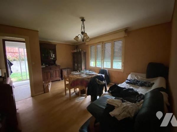 Une maison d'habitation construite en agglomérés de ciment et couverte en ardoises composée : ...