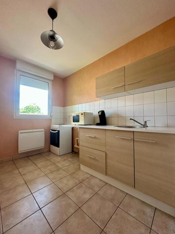 Appartement avec 2 chambres, balcon et place de parking