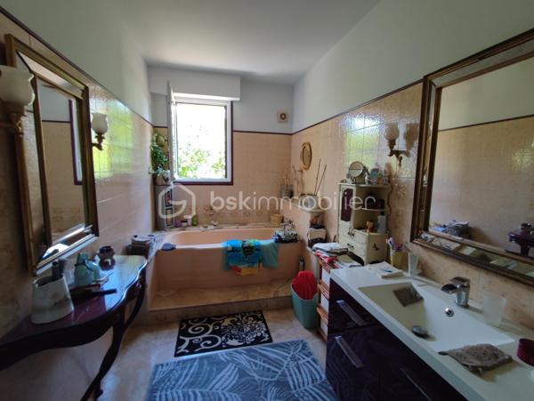 **À deux pas des commerces et de la gare – Élégante maison familiale de 234 m² avec sous-sol total, jardin paysager et piscine**

Idéalement située, à proximité immédiate des commerces et de la gare accessibles à pied, cette élégante propriété de **234 m² habitables** vous séduira par ses beaux volumes, sa luminosité et la qualité de ses prestations. Édifiée sur un terrain paysager de **880 m²**, elle bénéficie d'un environnement calme sans vis-à-vis.

Dès l'entrée, un vaste hall met en valeur un magnifique escalier en ferronnerie et distribue les pièces de vie notamment un accès sur une terrasse en pierre et un jardin. Vous découvrirez un vaste séjour salon** de 44 m²** avec cheminée ancienne, baigné de lumière grâce à ses nombreuses ouvertures. La cuisine, entièrement équipée, est à la fois fonctionnelle et conviviale.

Le rez-de-chaussée comprend également une chambre, un bureau, une salle de bains ainsi que des toilettes indépendantes, offrant une véritable vie de plain-pied.

À l'étage, une spacieuse pièce palière dessert **trois grandes chambres avec espaces dressing**, dont une disposant d'un cabinet de toilettes privatif, une salle de bains et un WC indépendant.

Un **grenier aménageable d'environ 60 m²** complète l'ensemble et offre un beau potentiel pour créer des chambres supplémentaires, une salle de jeux ou un espace de loisirs.

Le sous-sol total est un véritable atout. Il comprend un **garage double**, un atelier, une salle d'eau ainsi qu'une chaufferie buanderie, offrant de nombreux espaces de rangement et de travail.

À l'extérieur, vous profiterez d'une belle terrasse en pierre, d'un jardin soigneusement paysagé et d'une piscine hors sol, idéale pour les beaux jours.

**Prestations de qualité :**

* Pompe à chaleur air/eau.
* Chaudière à granulés.
* Ballon thermodynamique.
* Pas de vis-à-vis. 
* Toiture en ardoise.
* Double vitrage.
* Volets roulants électriques.
* Sol du rez-de-chaussée en marbre.
* Tout-à-l'égout.
* Sous-sol total avec garage double.
* Grenier aménageable de 60 m².
* Commerces et gare accessibles à pied.

Une maison familiale aux prestations soignées, alliant confort, volumes et emplacement privilégié.