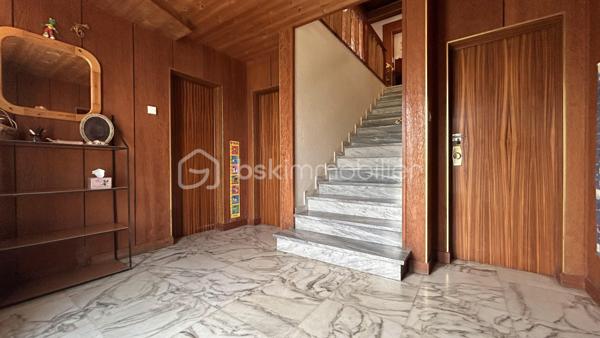 En exclusivité avec Patricia Acquaviva, au cœur du quartier recherché de la Commanderie à Échirolles, découvrez cette spacieuse maison familiale construite en 1969 développant environ 200 m² habitables sur une agréable parcelle de 647 m², offrant de beaux volumes et de nombreuses possibilités d'aménagement.

Dès l'entrée, vous serez séduits par son potentiel et sa configuration idéale pour accueillir une grande famille ou un projet de vie multigénérationnel.

Le rez-de-chaussée se compose d'une belle entrée desservant une chambre, un séjour, une salle d'eau, un WC indépendant, une buanderie ainsi qu'une chaufferie. Vous bénéficierez également de deux garages dont un directement intégré à la maison avec porte motorisée et un second aménagé dans une dépendance en bois.

À l'étage, vous profiterez d'un lumineux séjour ouvrant sur une terrasse et un balcon, d'une cuisine indépendante pouvant facilement être ouverte sur la pièce de vie selon vos envies, de trois chambres dont une véritable suite parentale avec sa salle de bain privative, d'une salle d'eau supplémentaire ainsi que d'un WC indépendant.

Des combles viennent compléter l'ensemble et offrent un espace de stockage appréciable.

Un studio indépendant d'environ 23 m² avec kitchenette, salle d'eau et WC constitue un véritable atout pour accueillir famille et amis, exercer une activité professionnelle ou envisager un revenu locatif complémentaire.

Cette maison représente une opportunité intéressante pour un investissement locatif, la création de plusieurs logements indépendants ou encore pour un projet familial multigénérationnel permettant à chacun de conserver son autonomie tout en partageant un même lieu de vie.

Côté prestations, la maison est équipée de menuiseries en aluminium et PVC, de volets roulants électriques sur l'ensemble des ouvertures et est raccordée au tout-à-l'égout. 
Le chauffage est assuré par une chaudière au fioul.

Des travaux sont à prévoir afin de révéler tout le potentiel de cette propriété aux nombreux atouts.

Vous apprécierez enfin sa situation privilégiée à proximité de la rocade, des commerces, des écoles et des commodités tout en profitant d'un environnement agréable et résidentiel.

Une maison pleine de possibilités où chacun pourra imaginer et créer son futur cadre de vie, que ce soit pour une résidence principale familiale, un projet multigénérationnel ou un investissement à forte valeur ajoutée.
Ne tardez pas à venir la découvrir lors d'une visite.