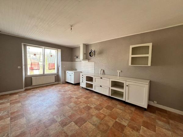 Maison mitoyenne avec terrasse, garages et potentiel d’aménagement