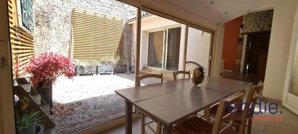 Maison de ville spacieuse avec patio, véranda et potentiel d’aménagement.