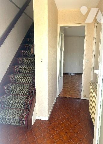 En centre-ville, à proximité des commerces, maison sur 2 niveaux avec garage et jardin clos