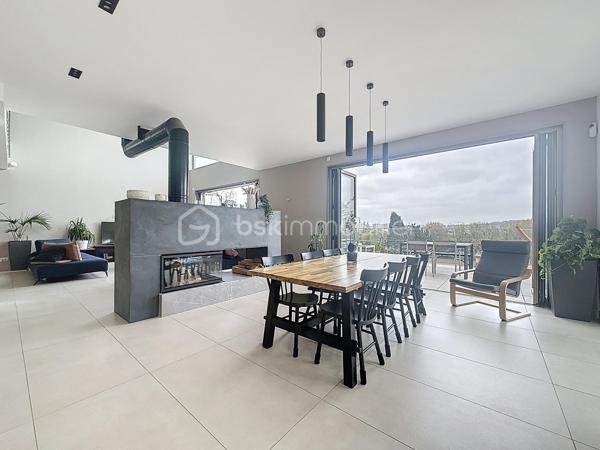 L’art de vivre contemporain aux portes de Paris! 
Située dans un environnement résidentiel privilégié en bord de Seine, cette exceptionnelle villa d’architecte neuve de 357 m² habitables offre un panorama spectaculaire sur la Seine, La Défense et la Tour Eiffel.
Édifiée sur un terrain paysager de 1 744 m², cette propriété séduit par ses volumes généreux, sa luminosité omniprésente, ses prestations haut de gamme et son architecture contemporaine ouverte sur l’extérieur. Les vastes terrasses bois avec claustras et brise-soleil, la piscine de 46 m²chauffée avec espace détente et une cuisine d’été et le séjour cathédrale avec cheminée centrale 360° créent une atmosphère unique entre élégance, confort et art de vivre.

Une distribution pensée pour le confort et la réception. 
•	11 pièces principales 
•	8 chambres dont 3 avec accès terrasse et 1 avec accès PMR
•	Suite parentale avec dressing, salle de bains et terrasse 
•	7 salles d’eau dont 6 privatives 
•	Salle à manger et séjour cathédrale avec vue panoramique 
•	Cuisine américaine avec cellier fermé
•	Appartement indépendant avec 2 chambres et 1 séjour cuisine américaine
•	Garage fermé 3 véhicules + stationnements extérieurs 
À cela s’ajoutent plusieurs espaces annexes non comptabilisés dans la surface habitable : une buanderie, une cave à vins et deux locaux techniques dédiés à la piscine de 46 m² ainsi qu’aux équipements énergétiques de la propriété, pompes à chaleur et centrale double flux.

Rez-de-chaussée surélevé: 
Le niveau principal offre une cuisine américaine avec cellier ouverte sur un spectaculaire séjour cathédrale avec cheminée centrale 360°, baigné de lumière et prolongé par les terrasses et la piscine.
Une salle à manger élégante complète les espaces de réception.
Ce niveau accueille également :
- une chambre avec salle d’eau et WC accessibles PMR (rampe extérieure),
- une suite parentale avec terrasse, dressing, salle de bains avec baignoire et douche à l’italienne double ciel de pluie, ainsi que des WC séparés.

Étage: 
Un élégant escalier sculptural en bois massif, conçu comme une estrade bibliothèque contemporaine, mène à l’étage desservi par une passerelle architecturale.
L’espace nuit comprend :
- 4 chambres avec salle d’eau privative, dont 2 avec terrasse et vue panoramique,
- 2 WC séparés,
- Rangements et gaine à linge reliant directement la buanderie.

Rez-de-jardin : 
Le rez-de-jardin propose des espaces fonctionnels comprenant une entrée indépendante, un vestiaire, une buanderie, une cave à vins, des rangements et un local technique équipé de pompes à chaleur et d’une centrale double flux alimentée par panneaux solaires et photovoltaïques.
Un appartement indépendant complète ce niveau avec:
- séjour et cuisine ouverte
- 2 chambres
- 1 salle d’eau et WC séparés

Environnement & cadre de vie
Cadre résidentiel privilégié en bord de Seine, offrant un équilibre rare entre nature et proximité de Paris.
•	Berges de Seine et chemin de halage à 2 min à pied 
•	Parcours des Impressionnistes à proximité 
•	Île des Impressionnistes de Chatou à 10 min 
•	Jardins de Mademoiselle de La Vallière à 10 min à pied 
Vie de quartier & commodités
À seulement 12 km de Paris, accès rapide aux transports et principaux pôles d’affaires.
•	Gare Houilles / Carrières-sur-Seine (RER A, lignes J & L) à 10 min 
•	Paris Saint-Lazare en 24 min 
•	Accès rapide A86, A14 et La Défense 
•	Commerces et supermarchés à proximité immédiate 

Établissements scolaires
Écoles, collège et lycée accessibles rapidement.
Établissements bilingues et internationaux à proximité : Montessori bilingue, The British School of Paris, Lycée International de Saint-Germain-en-Laye et Ermitage International School.

Prestations & équipements haut de gamme
•	Construction RT 2012 – Prestations énergétiques premium DPE A
•	Plancher chauffant et rafraîchissant sur 3 niveaux 
•	Pompe à chaleur, climatisation et centrale double flux 
•	Panneaux solaires hybrides et photovoltaïques 
•	Menuiseries aluminium, double vitrage et volets motorisés 
•	Cheminée centrale 360° 
•	Piscine chauffée avec espace détente 
•	3 Terrasses bois et pierre avec brise-soleil et claustras 
•	Garage fermé 3 véhicules + stationnements extérieurs 
•	Matériaux nobles et finitions premium

Une propriété rare destinée aux amateurs de lieux uniques recherchant un équilibre parfait entre nature, architecture contemporaine et proximité immédiate de Paris.
Découvrez cette propriété d’exception lors d’une visite privée.