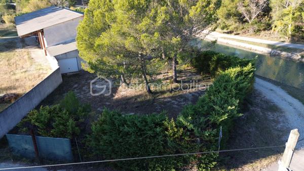 À vendre – Hangar d’environ 400 m² sur terrain de 3 137 m² – Au pied du Luberon

Situé en pleine campagne, au pied du Luberon, dans un environnement calme, naturel et préservé, ce hangar d’environ **400 m²** est implanté sur une belle parcelle plate de **3 137 m²**, exposée plein sud.
Initialement destiné à une activité de **garage automobile et de mécanique**, ce bien offre un beau potentiel pour un projet professionnel ou de stockage.
Le terrain est viabilisé : le hangar est raccordé à **l’eau de ville et à l’électricité** et dispose d’un **assainissement individuel par fosse septique conforme aux normes en vigueur**.
La parcelle est située en **zone agricole et non constructible**. Il est donc important de préciser que **le bien ne peut pas être utilisé à usage d’habitation** et qu’aucune construction à vocation résidentielle ne peut y être réalisée.
L’environnement est particulièrement recherché, avec très peu de constructions aux alentours, offrant ainsi un cadre paisible et préservé, aux portes du Luberon.
Un bien rare dans un secteur prisé, idéal pour un projet professionnel, une activité artisanale, du stockage ou un usage correspondant à la réglementation applicable en zone agricole.**

Et un  Bureau  de plain-pied – 3 pièces – 73 m² – Parcelle 397 m²
Ce bureau qui a l'apparence d'une maison habitable ,  est actuellement en usage de bureau ,une déclaration préalable pour l'usage en habitation est en cours .
Il est mitoyen à un hangar .
Situé au pied du Luberon, construit en 1990, offre un cadre de vie privilégié sur une parcelle entièrement close et arborée de 397 m².
D’une superficie d’environ 73 m² habitables, il se compose d’un vaste séjour lumineux, d’une cuisine ouverte, de deux chambres, d’une salle d’eau, d’un WC indépendant, d’une mezzanine offrant un espace supplémentaire polyvalent, ainsi que d’un garage.
À l’extérieur, une terrasse permet de profiter pleinement des belles journées provençales.
La toiture est en amiante .
La propriété offre la possibilité de stationner plusieurs véhicules à l’intérieur du jardin.
Il est idéalement situé au calme, au pied de la colline, et bénéficie d’un environnement naturel privilégié.
Il est raccordé à une fosse septique conforme.