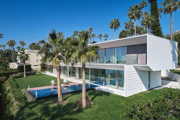 Nichée au cœur de l’un des domaines privés les plus prisés de Cannes, à deux pas du littoral, cette somptueuse villa contemporaine conjugue avec élégance luxe, design et quiétude.

Inspirée par l’architecture californienne, la propriété développe environ 500 m² habitables sur un terrain paysagé de 2245 m², offrant une vue imprenable sur la mer et l’île Sainte-Marguerite. De larges baies vitrées laissent généreusement entrer la lumière, effaçant les frontières entre intérieur et extérieur.

Distribution idéale sur plusieurs niveaux :

Rez-de-chaussée : hall d’entrée raffiné, toilettes invités, vaste séjour, salle à manger lumineuse, cuisine haut de gamme avec arrière-cuisine, deux chambres avec salles d’eau attenantes

Étage : spectaculaire suite parentale avec dressing et salle de bains, deux autres chambres en suite avec salles de douches privatives

Sous-sol : garage pour 4 véhicules, salon TV, hammam, salle de sport entièrement équipée, buanderie, toilettes, chambre de service avec salle de douche, et salle de massage

Cette propriété d’exception bénéficie également :

d’un ascenseur desservant tous les étages

d’une climatisation centralisée

d’une piscine à débordement chauffée à effet miroir

Son architecture aux lignes épurées, ses volumes généreux et ses prestations haut de gamme incarnent l’art de vivre californien au cœur de la Côte d’Azur.

Photos complémentaires sur demande

ENGLISH – Contemporary Sea View Villa – Private Estate in Cannes
Set in one of Cannes' most exclusive private estates, just steps from the coastline, this stunning contemporary villa offers a rare blend of luxury, modern design, and absolute serenity.

Inspired by Californian architecture, the residence boasts approximately 500 sqm of living space on a beautifully landscaped 2245 sqm plot, with breathtaking views over the sea and the Sainte-Marguerite Island. Floor-to-ceiling windows flood the interiors with natural light, creating a seamless connection between indoor and outdoor living.

Thoughtfully designed across several levels:

Ground floor: elegant entrance hall, guest WC, spacious living room, bright dining area, fully fitted kitchen with utility room, two en-suite bedrooms

First floor: luxurious master suite with walk-in wardrobe and en-suite bathroom, plus two additional en-suite bedrooms

Lower level: garage for up to 4 cars, TV lounge, hammam, fully equipped gym, laundry room, additional WC, staff bedroom with shower room, and a private massage room

The villa also features:

a lift serving all floors

central air conditioning

a heated infinity mirror pool

With its clean architectural lines, expansive sunlit interiors, and refined finishes, this home perfectly embodies the Californian lifestyle on the French Riviera.

Additional photos available on request