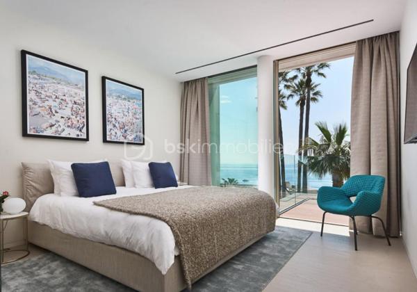 Nichée au cœur de l’un des domaines privés les plus prisés de Cannes, à deux pas du littoral, cette somptueuse villa contemporaine conjugue avec élégance luxe, design et quiétude.

Inspirée par l’architecture californienne, la propriété développe environ 500 m² habitables sur un terrain paysagé de 2245 m², offrant une vue imprenable sur la mer et l’île Sainte-Marguerite. De larges baies vitrées laissent généreusement entrer la lumière, effaçant les frontières entre intérieur et extérieur.

Distribution idéale sur plusieurs niveaux :

Rez-de-chaussée : hall d’entrée raffiné, toilettes invités, vaste séjour, salle à manger lumineuse, cuisine haut de gamme avec arrière-cuisine, deux chambres avec salles d’eau attenantes

Étage : spectaculaire suite parentale avec dressing et salle de bains, deux autres chambres en suite avec salles de douches privatives

Sous-sol : garage pour 4 véhicules, salon TV, hammam, salle de sport entièrement équipée, buanderie, toilettes, chambre de service avec salle de douche, et salle de massage

Cette propriété d’exception bénéficie également :

d’un ascenseur desservant tous les étages

d’une climatisation centralisée

d’une piscine à débordement chauffée à effet miroir

Son architecture aux lignes épurées, ses volumes généreux et ses prestations haut de gamme incarnent l’art de vivre californien au cœur de la Côte d’Azur.

Photos complémentaires sur demande

ENGLISH – Contemporary Sea View Villa – Private Estate in Cannes
Set in one of Cannes' most exclusive private estates, just steps from the coastline, this stunning contemporary villa offers a rare blend of luxury, modern design, and absolute serenity.

Inspired by Californian architecture, the residence boasts approximately 500 sqm of living space on a beautifully landscaped 2245 sqm plot, with breathtaking views over the sea and the Sainte-Marguerite Island. Floor-to-ceiling windows flood the interiors with natural light, creating a seamless connection between indoor and outdoor living.

Thoughtfully designed across several levels:

Ground floor: elegant entrance hall, guest WC, spacious living room, bright dining area, fully fitted kitchen with utility room, two en-suite bedrooms

First floor: luxurious master suite with walk-in wardrobe and en-suite bathroom, plus two additional en-suite bedrooms

Lower level: garage for up to 4 cars, TV lounge, hammam, fully equipped gym, laundry room, additional WC, staff bedroom with shower room, and a private massage room

The villa also features:

a lift serving all floors

central air conditioning

a heated infinity mirror pool

With its clean architectural lines, expansive sunlit interiors, and refined finishes, this home perfectly embodies the Californian lifestyle on the French Riviera.

Additional photos available on request