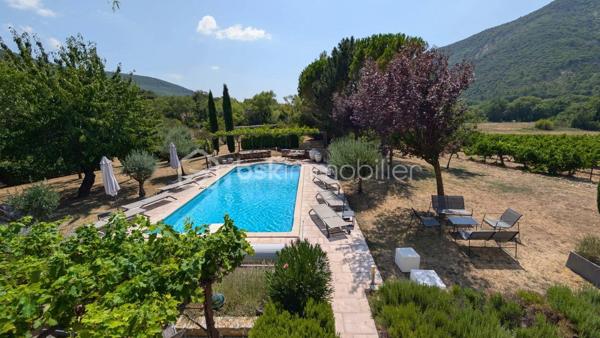 MAS XVIIIᵉ EN PIERRE • 340 M² • 8 CHAMBRES • PISCINE CHAUFFÉE • DRÔME PROVENÇALE

Au cœur de la Drôme provençale, entre Grignan et Dieulefit, découvrez ce remarquable mas en pierre datant du XVIIIᵉ siècle, restauré dans le respect de son authenticité et développant environ 340 m² habitables.

Organisé en L autour d'une ravissante cour intérieure d'environ 93 m², véritable cœur du mas, l'ensemble bénéficie d'une configuration particulièrement intéressante permettant de recevoir famille, amis ou hôtes tout en préservant l'intimité de chacun.

Une première aile accueille l'habitation principale. Depuis une belle terrasse bénéficiant d'une vue remarquable sur les paysages environnants, l'entrée ouvre sur une généreuse pièce de vie avec cuisine ouverte de 52,89 m².

Elle se prolonge par une suite parentale, une seconde chambre disposant de sa baignoire ainsi qu'une troisième chambre aménagée sous pente. Un grenier complète cette partie.

Dans l'autre aile, l'atmosphère se fait particulièrement chaleureuse avec un salon équipé d'un poêle à bois, prolongé par une salle à manger où l'ancienne mangeoire en pierre, soigneusement conservée, rappelle l'histoire et la vocation originelle des lieux.

Une arrière-cuisine ainsi qu'une cave à vin de 21,13 m² complètent ce niveau.

À l'étage, deux chambres disposent chacune de leur salle d'eau privative.

Côté cour et piscine, trois chambres supplémentaires bénéficient chacune de leur propre espace d'eau avec douche ou baignoire, offrant une belle indépendance à leurs occupants.

Le mas totalise ainsi 8 chambres et une capacité d'accueil particulièrement appréciable, avec une distribution adaptée aussi bien à une vie familiale qu'à une activité d'hébergement.

La rénovation a su préserver toute l'âme du bâti ancien : pierres et poutres apparentes, tomettes, pierres de taille, volumes généreux et éléments d'origine composent une atmosphère authentique, associée au confort actuel.

À l'extérieur, le mas est implanté sur environ 6 200 m² de terrain plat et arboré, dans un cadre préservé, sans voisinage immédiat et largement ouvert sur la campagne environnante.

Terrasses, espaces ombragés et perspectives dégagées invitent à profiter pleinement des lieux au fil des saisons.
La piscine chauffée et sécurisée de 5 × 10 m constitue un véritable espace de détente.

Un terrain de pétanque, un puits, un abri double pour deux véhicules, un vaste espace de stationnement ainsi que différentes annexes viennent compléter l’ensemble.
Par ses volumes, sa capacité d'accueil et son organisation permettant de préserver plusieurs univers de vie, ce mas se prête aussi bien à une grande maison de famille en résidence principale ou secondaire, qu'à un projet de location saisonnière, chambres d'hôtes ou gîtes.

Une propriété de caractère à la configuration rare, destinée aux amateurs de vieilles pierres et de lieux ayant conservé une véritable identité, dans un secteur privilégié de la Drôme provençale.

Informations et visites : contactez L’Immo By Céline PASCAL au 06 63 10 02 35.