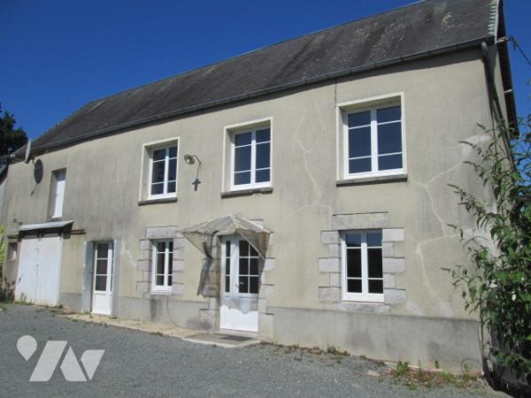 Une maison à usage d'habitation avec garage + terrain