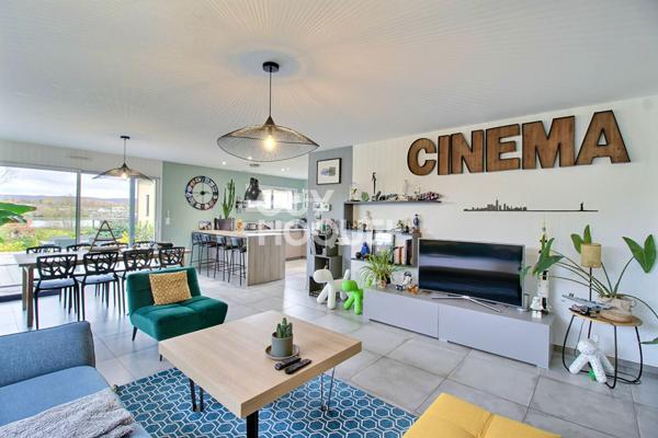 Maison contemporaine avec piscine chauffée et garage.