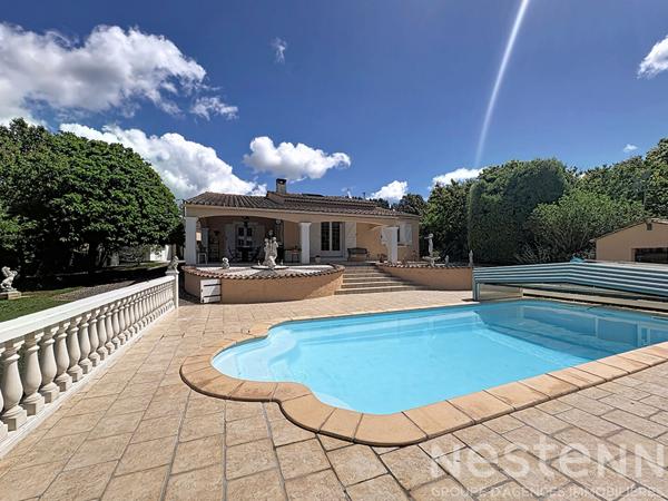 Maison de plain pied 3 chambres avec mezzanine sur un terrain clos de 2040 m² avec piscine et double garage.