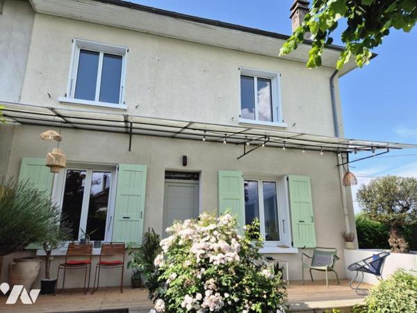 Maison mitoyenne de 82 m² avec jardin paysager de 476 m², grand garage et cave