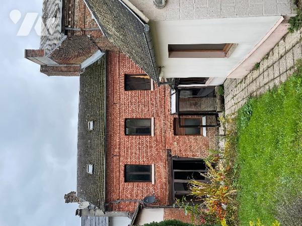 A VENDRE maison mitoyenne en briques avec entrée cochère.