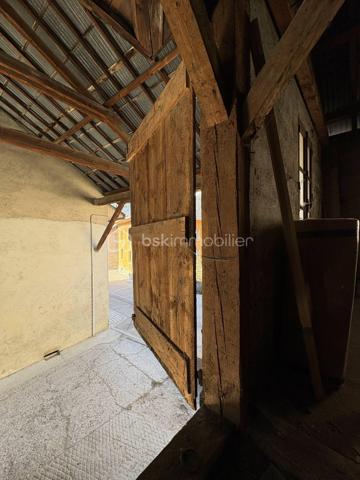 Un lieu chargé d’histoire, au centre d’un village de montagne authentique, offrant un potentiel rare.
Cette bâtisse en pierre, autrefois la forge du village, se situe au cœur de La Compôte, dans le massif préservé des Bauges. Elle bénéficie d’un environnement naturel exceptionnel : départs de randonnées, lacs, stations et paysages alpins accessibles en quelques minutes.

Un permis existant et un potentiel d’évolution remarquable
Le permis de construire actuellement validé prévoit deux plateaux pour une surface totale d’environ 135 m² aménageables.
Ce cadre offre déjà une base solide pour un projet d’habitation ou d’investissement.
Mais l’intérêt majeur réside dans la possibilité de modifier ce permis, ouvrant la voie à des aménagements plus ambitieux, jusqu’à environ 160 m² habitables selon les configurations.

Plusieurs scénarios deviennent alors envisageables:
Un grand logement familial de type T5
Deux logements distincts (T3 + T5)
Un projet modulé selon vos besoins, vos envies ou votre stratégie patrimoniale
La hauteur sous plafond et la charpente apparente permettent d’imaginer des volumes lumineux, uniques, avec un cachet exceptionnel.

 Caractéristiques et atouts:
Bâtisse en pierre, saine et rassurante
Raccordement électrique réalisé
Toiture partiellement refaite en bac acier (reste en tôle en bon état)
Possibilité de stationnement privatif couvert
Espaces terrasses exploitables
Volume intéressant pour entreposer du matériel ou créer un espace de travail selon projet
Idéal pour un investissement locatif, un projet familial ou un lieu de vie atypique

 Travaux à prévoir:
*Raccordement au tout-à-l’égout
*Raccordement à l’eau
*Aménagement intérieur complet selon le projet retenu

Un lieu à ressentir
Cette ancienne forge est un lieu qui se visite pour en saisir l’âme et le potentiel.
Même sans terrain, la nature environnante devient votre véritable espace extérieur : forêts, montagnes, sentiers, activités de plein air… Un cadre de vie rare.
La lumière, les volumes et la charpente confèrent à cette bâtisse un charme unique, difficile à percevoir sans s’y rendre.
Pour vous aider à vous projeter, un travail d’esquisse et de réflexion a été mené avec Chlôme (architecte / maître d’œuvre). Cette approche, indépendante du permis de construire existant, ouvre des perspectives intéressantes pour un futur projet.

Je reste à votre écoute pour toute question et, si cette bâtisse éveille votre intérêt, je suis disponible pour vous la faire visiter.