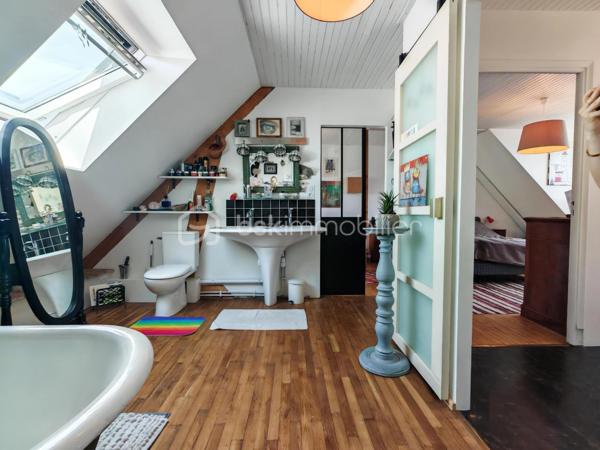 Construite vers 1950 et entièrement rénovée avec personnalité, cette maison bretonne singulière se déploie sur 3 niveaux (avec possibilité d'aménager un 4ᵉ niveau) dans un style éclectique affirmé. Une demeure pleine d'âme, prête à accueillir ses futurs propriétaires.
Surfaces : 111 m² habitables, complétés par environ 80 m² au rez-de-jardin.
Emplacement idéal : à quelques pas du centre-ville, des écoles, des commerces et des transports, la maison conjugue praticité et environnement paisible.

3 min de la quatre-voies
5 min de la gare
15 min de Lorient

Rez-de-jardin : garage, buanderie et atelier occupant toute l'emprise du bâtiment — un fort potentiel d'aménagement. Le grand jardin, planté d'un cognassier, accueille également un cabanon pouvant abriter lapins ou poules.
1er étage : belle entrée centrale, lumineuse et chaleureuse, distribuant l'ensemble des pièces. Elle ouvre sur une cuisine, une chambre, une salle d'eau moderne (douche à l'italienne et WC) ainsi qu'un double séjour donnant directement sur une terrasse sur pilotis plein sud, qui mène au jardin. Luminosité exceptionnelle et vue perchée particulièrement apaisante.
2ᵉ étage : vaste chambre avec coin bureau, superbe salle de bains (double vasque, baignoire en fonte, WC, verrière), dressing pouvant être transformé en chambre indépendante, ainsi qu'une 3ᵉ chambre.
Grenier : 80 m² au sol, aménageable en pièce de vie supplémentaire avec possibilité d'installation de Velux (sous réserve d'accord), ou à transformer en volume cathédrale sous charpente apparente.
Prestations techniques : chauffage au gaz (chaudière récente), poêle à bois, plomberie refaite à neuf.

En résumé : une maison à l'âme bobo assumée, sans compromis et sans travaux à prévoir, à proximité immédiate du centre-ville. Posez simplement vos valises !