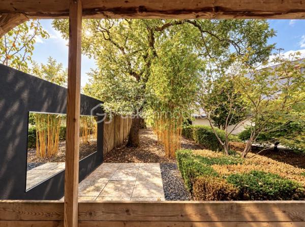 MAISON D’ARCHITECTE – 5 CHAMBRES – VIE DE PLAIN-PIED – TERRAIN 1 378 M² – GARAGE & CARPORT
Découvrez cette maison d’architecte familiale, lumineuse et sans vis-à-vis, implantée dans un environnement calme sur un magnifique terrain arboré et paysager de 1 378 m².
Elle offre de beaux volumes et une organisation idéale pour une famille, avec 4 chambres au rez-de-chaussée, dont une avec dressing et salle d’eau attenante.
La pièce de vie comprend une cuisine aménagée et équipée avec espace repas, ouverte sur un chaleureux salon-salle à manger avec cheminée. Les espaces de vie donnent directement sur deux terrasses, dont l’une dispose d’un espace repas extérieur abrité par un préau, avec vue sur le jardin.
Une salle de bains, deux WC, un débarras et de nombreux rangements complètent le rez-de-chaussée.
À l’étage : une 5e chambre, une mezzanine pouvant accueillir bureau, bibliothèque, salle de sport ou couchage supplémentaire, ainsi que des combles.
Garage, carport et cave complètent l’ensemble.
Les + : maison d’architecte, 5 chambres, vie de plain-pied, beaux volumes, luminosité, cheminée, deux terrasses, jardin paysager sans vis-à-vis, garage, carport, cave et transports scolaires desservant directement la rue.
Une maison familiale aux volumes généreux, où les espaces de vie s’ouvrent naturellement sur les terrasses et le jardin.