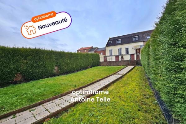 Le Cateau - Maison semi-individuelle à double accès avec garage, devanture & jardin clos.