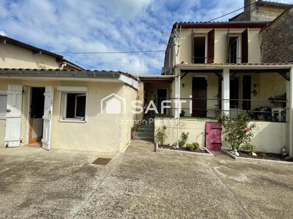 Maison en pierre mitoyenne : 2 chambres, jardin, garage et un potentiel studio !