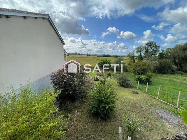 Maison en pierre mitoyenne : 2 chambres, jardin, garage et un potentiel studio !