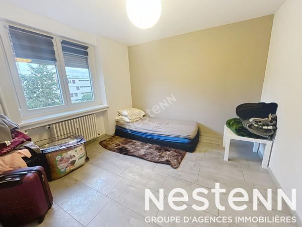 Appartement - 2 chambres - lumineux - balcon - stationnement - garage - cave - grenier