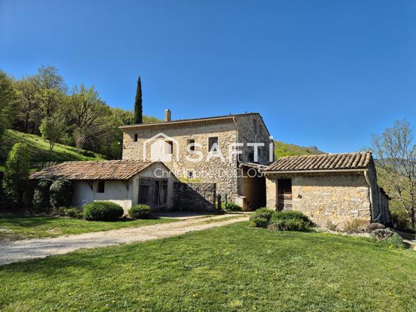 Spacieuse bastide en pierres avec dépendances et jardin paysager.