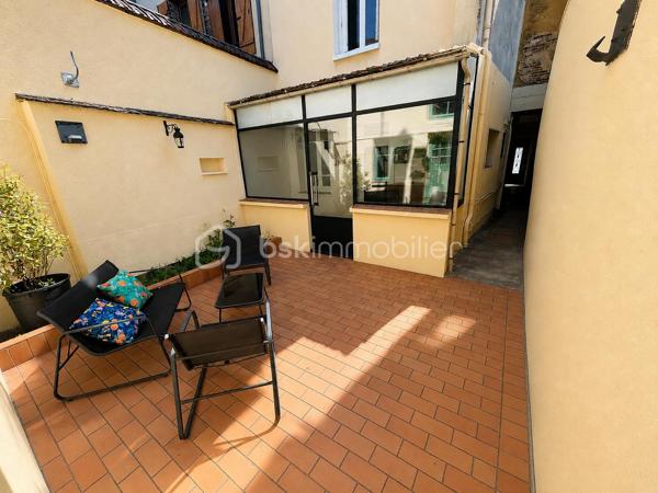 Découvrez cette agréable maison de ville offrant de beaux volumes et un fort potentiel, idéale pour une famille ou un projet d'investissement. 
Au rez-de-chaussée, vous serez accueilli par une véranda lumineuse desservant une cuisine conviviale ainsi qu'une salle à manger chaleureuse. 
Le premier étage se compose d'un salon confortable, d'une chambre ainsi que d'une salle de bains avec toilettes. 
Au deuxième étage, l'espace nuit propose deux chambres supplémentaires et un cabinet de toilettes. 
A l'extérieur, vous profiterez d'une première cour menant à une dépendance d'environ 19 m². Un jardin dessert deux garages dont l'un est actuellement loué, offrant ainsi un revenu locatif complémentaire. Les garages bénéficient d'un accès sur une autre rue, un véritable atout en termes de praticité. 
Cette maison pleine de charme saura séduire les acquéreurs à la recherche d'un bien fonctionnel avec des possibilités d'aménagement.