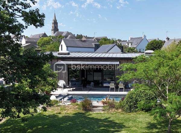 Une exclusivité Sonia Rozwadower - BSK immobilier : 

Idéalement située en plein bourg de Ploemel, au fond d’une impasse garantissant calme et tranquillité, découvrez cette maison contemporaine de plain-pied construite en 2012, offrant 117 m² habitables sur un terrain paysagé de 858 m².

Dès l’entrée, vous serez séduits par sa vaste pièce de vie de près de 59 m², baignée de lumière grâce à une baie vitrée de 5 mètres ouvrant sur une terrasse en bois d’environ 32 m² exposée sud-est. Cet espace convivial comprend un séjour chaleureux avec poêle à bois, une salle à manger et une cuisine aménagée et équipée.

L’espace nuit se compose d’une suite parentale de 17 m² avec dressing et salle de bain privative, de deux belles chambres d’environ 14 m² chacune, d’une salle d’eau indépendante ainsi que d’un WC séparé.

À l’extérieur, profitez pleinement des beaux jours grâce à une piscine de 7 x 4 mètres en béton, équipée d’un volet roulant, d’une pompe à chaleur et d’un traitement au sel. Sa profondeur de 1,50 m en fait un espace idéal pour toute la famille.

Les prestations complémentaires comprennent un garage de 22 m², une buanderie de 17 m², une aspiration centralisée, un chauffe-eau de 300 litres ainsi qu’un système de chauffage par pompe à chaleur.

Atout  : la configuration de la maison permet la réalisation d'une extension d'environ 36 m² au sol avec accès indépendant, offrant une opportunité pour l'installation d'une profession libérale, la création d'un bureau indépendant, d'un espace de télétravail, d'un cabinet de consultation ou encore d'un logement complémentaire selon les autorisations en vigueur.

Une maison récente, alliant confort, fonctionnalité et potentiel d'évolution, à proximité immédiate des commerces, écoles et services du bourg.

Un bien aux multiples possibilités, à découvrir sans tarder. N'hésitez pas à me contacter pour organiser une visite!