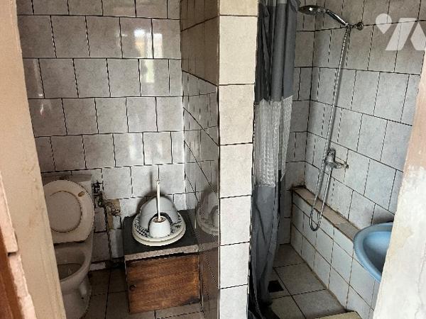 Maison d'habitation comprenant : salon-séjour, cuisine, chambre, salle de bains, deux pièces, jardin