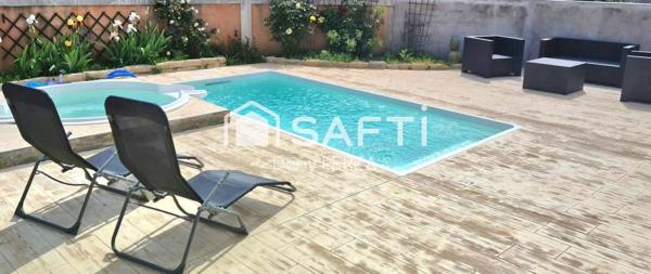 Villa avec piscine, jacuzzi, jardin et garage.