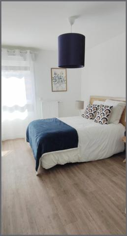 Appartement rez-de-chaussée 65 m² avec balcon - 2 chambres - garage.