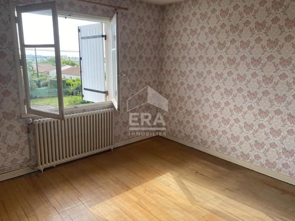 Maison familiale avec jardin, garage et fort potentiel d'aménagement