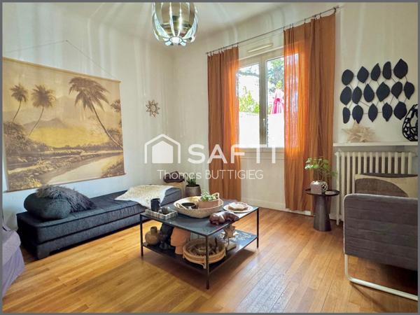 Maison de ville avec garage et jardin.