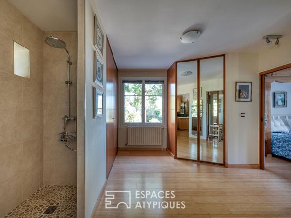 Maison familiale avec jardin arboré et piscine intérieure.