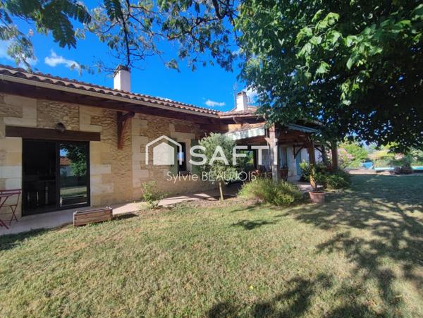 Propriété en pierre avec piscine et jardin arboré.
