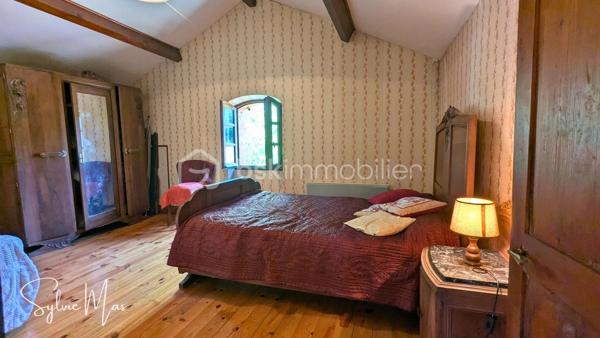Au bout d'un chemin de terre, à l'abri de toute circulation automobile, la maison réf.*Madeleine* offre un espace hors du temps.
Bordant l'ancienne ligne ferroviaire aujourd'hui transformée en voie verte, cette ancienne maison de garde-barrière bénéficie d'un environnement rare, entre vignes, prairies et bois. Ici, le calme est ponctué par le passage des cyclistes, tandis que la rivière Lot, située à quelques minutes, ravira les amateurs de pêche, de canoë, de balades au fil de l'eau et plus largement les amoureux de nature.

Édifiée sur un terrain arboré de 2 218 m2 , cette charmante maison d'environ 63 m² séduira les personnes en quête d'authenticité et d'un cadre de vie préservé.
Le rez-de-chaussée accueille une agréable pièce de vie de 17 m2 avec coin cuisine et une belle cheminée ouverte, un coin salon de 10 m2 pouvant également faire office de chambre, une salle d'eau avec WC ainsi qu'un accès à une magnifique cave voûtée.
À l'étage, deux chambres traversantes (14 et 16,5 m2) composent l'espace nuit.
À l'extérieur, une terrasse, un abri de jardin avec chenil attenant ainsi que le terrain arboré complètent cet ensemble plein de charme.
Si vous recherchez un lieu authentique où passer vos week-ends, vos vacances ou simplement vous reconnecter à la nature, *Madeleine* mérite assurément une visite.