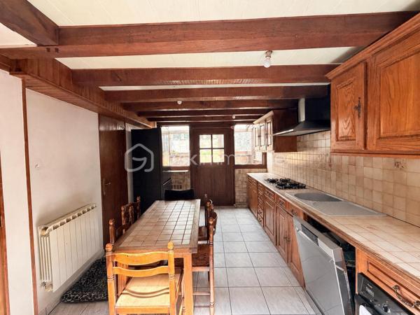 Située à proximité du centre, cette maison en pierre mitoyenne des 2 cotés offre un beau potentiel à ses futurs propriétaires. 
Nous commencerons la visite par la salle de 27m2 avec le charme des murs en pierres apparentes, en enfilade le salon de 20m2 puis toujours en enfilade la cuisine aménagée de 12m2. De la cuisine nous accédons à une cave de 13m2 et au wc séparé de 2m2. Pour un peu plus de rangement, de la cuisine nous accédons à une petite véranda non chauffée qui donne elle accès au jardin. 
Nous poursuivrons avec l'étage. Une mezzanine de 12m2 idéale pour y aménager un bureau ou encore un coin détente distribue l'accès aux trois chambres et à la salle de bain de 6m2 environ. La première chambre fait 14m2 dont un cabinet de toilettes privatif de 2m2 environ, la seconde chambre fait 18m2 et en enfilade vous avez une troisième chambre de 18m2 également. Possibilité de leur donner un accès privatif. 
Nous terminerons la visite par le grenier de 30m2 qui vous offre la possibilité de l'aménager. 
Coté extérieur, vous pourrez profiter de la parcelle de 185m2 entièrement close. Une pergola a été installée pour profiter de ses extérieurs tout en étant protégé. Pas de garage. 
Le mode de chauffage est électrique. La toiture est en ardoises naturelles. Les menuiseries bois sont en double vitrage sauf celle de la cuisine qu'il faudra envisager de changer si vous le souhaitez. La taxe foncière est de 870€. 
Toutes les commodités, écoles et commerces sont à proximité.  
Alors, cette annonce semble correspondre à vos critères de recherche ? Appelez-moi !