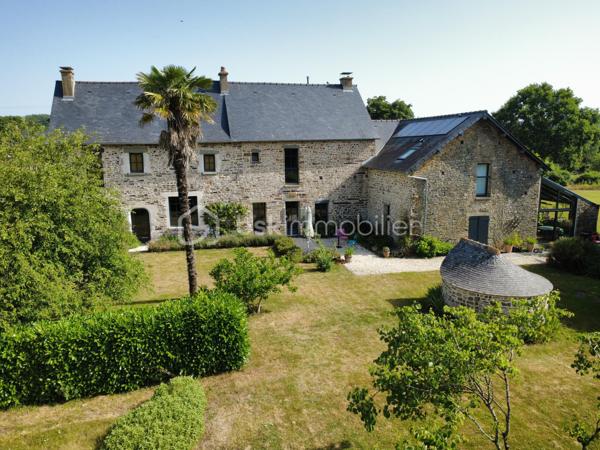 À proximité de Rennes, sur la commune de Guichen, venez découvrir en exclusivité cette demeure d’exception du 18ème siècle, entièrement rénovée, alliant charme authentique, matériaux de qualité et une performance énergétique digne d’une maison contemporaine !
Au cœur d’une parcelle de 5500 m2 entièrement clôturée, cette magnifique bâtisse en pierres d’une surface de 335m2 a été rénovée dans les règles de l’art par des professionnels.

Au rez de chaussée, un hall d’entrée tout en volume, avec rangements intégrés vous permettra d’accéder à un vaste salon-séjour très lumineux, puis à une cuisine remarquable chaleureuse et fonctionnelle et enfin à une suite parentale avec salle d’eau dont l’exposition Est vous permettra d’admirer chaque matin le lever de soleil par la véranda qui la termine.
De nombreux rangements, une cave, une buanderie, des toilettes complètent ce niveau.

Au 1er étage, vous accéderez à un vaste salon de détente avec bibliothèque, écran de cinéma amovible, 3 chambres spacieuses à la décoration raffinée, et avec pour chacune, une salle d’eau ou une salle de bain. Un bureau aux rangements multiples ainsi que 2 WC complètent ce niveau.

L’espace extérieur a été aménagé avec soin et respect de l’environnement : terrasse, pergola, spa, four à pain fonctionnel et cuisine d’été dans la véranda. Un élégant carport vous permettra d’abriter 2 véhicules.

Rare pour ce type de bien : des coûts de fonctionnement réduits !
Le chauffage est assuré par un système aérothermie avec planchers chauffants. Panneaux solaires et batteries associées permettent une réduction et un stockage de l’énergie électrique.
Une cuve de récupération d’eau de pluie de 5m3 enterrée alimente les WC et permet l’arrosage.

Les atouts de ce bien :
- bien rare à la prestance exceptionnelle
- rénovation complète haut de gamme
- performance énergétique B
- exposition optimale Est / Ouest
- situation stratégique avec Gare SNCF à quelques minutes à pied

VIDEO DE PRESENTATION EXTERIEURE DISPONIBLE SUR DEMANDE