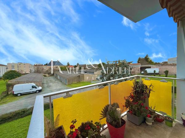 Appartement 2 chambres, balcon, cave privative et garage privatif