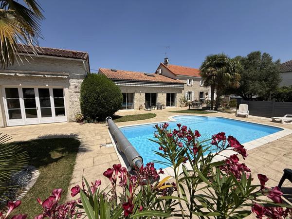 A proximité de Ruffec, magnifique maison en pierre de caractère offrant cinq chambres avec jardin, piscine et dépendances