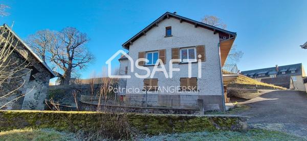 Maison T6 de 196 m² avec garages et jardin.