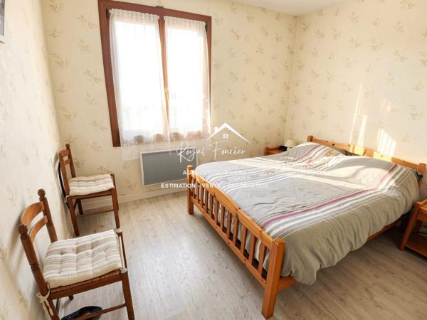 Vue sur la terrasse sous le préau et le jardin