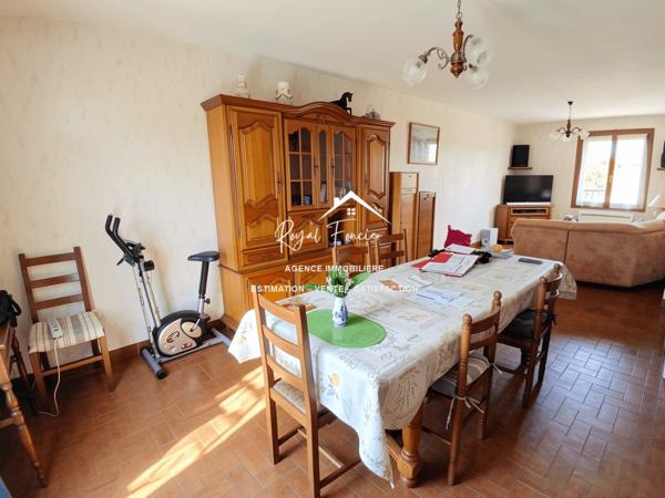 Vue sur la terrasse sous le préau et le jardin