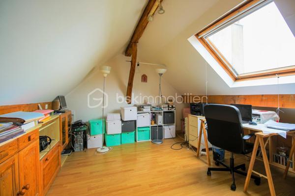 Venez découvrir cette maison atypique des années 1900 d’environ 105 m², édifiée sur une parcelle d’environ 430 m².

La maison vous accueille par une entrée ouverte sur une salle à manger, un salon avec cheminée fonctionnelle ainsi qu’une cuisine donnant directement accès au jardin situé à l’arrière de la maison.

Dès que l’on arrive sur la terrasse, l’atmosphère change complètement. Le jardin arboré, la verdure omniprésente et le calme qui s’en dégage donnent une véritable sensation de déconnexion. Un lieu agréable à vivre où l’on imagine facilement les repas d’été, les moments en famille ou simplement profiter du silence et de la nature.

À l’étage, la maison dispose de 3 chambres ainsi que d’une salle d’eau avec WC intégré. Les combles aménagés offrent également un bel espace complémentaire idéal pour un bureau, une salle TV ou une chambre d’appoint.

Un garage fermé ainsi qu’une cave complètent ce bien de caractère. Maison mitoyenne située à proximité des commerces, écoles et lignes de bus (1511, 1512 et 1517), à seulement 10 minutes du centre-ville.

Une maison avec une véritable âme, idéale pour les acquéreurs recherchant avant tout un cadre de vie paisible et chaleureux.