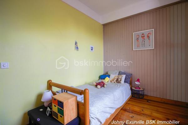 Venez découvrir cette maison atypique des années 1900 d’environ 105 m², édifiée sur une parcelle d’environ 430 m².

La maison vous accueille par une entrée ouverte sur une salle à manger, un salon avec cheminée fonctionnelle ainsi qu’une cuisine donnant directement accès au jardin situé à l’arrière de la maison.

Dès que l’on arrive sur la terrasse, l’atmosphère change complètement. Le jardin arboré, la verdure omniprésente et le calme qui s’en dégage donnent une véritable sensation de déconnexion. Un lieu agréable à vivre où l’on imagine facilement les repas d’été, les moments en famille ou simplement profiter du silence et de la nature.

À l’étage, la maison dispose de 3 chambres ainsi que d’une salle d’eau avec WC intégré. Les combles aménagés offrent également un bel espace complémentaire idéal pour un bureau, une salle TV ou une chambre d’appoint.

Un garage fermé ainsi qu’une cave complètent ce bien de caractère. Maison mitoyenne située à proximité des commerces, écoles et lignes de bus (1511, 1512 et 1517), à seulement 10 minutes du centre-ville.

Une maison avec une véritable âme, idéale pour les acquéreurs recherchant avant tout un cadre de vie paisible et chaleureux.