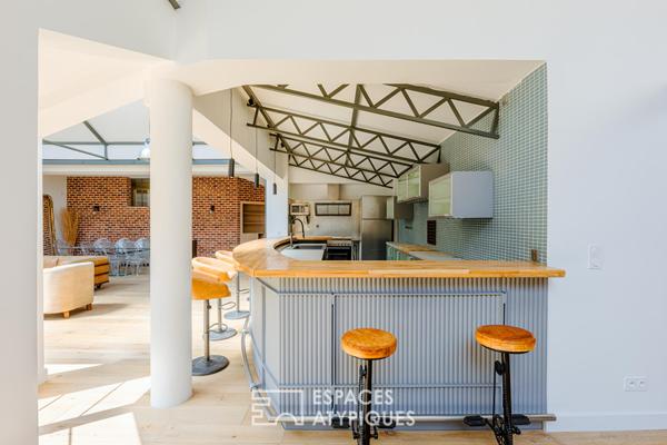 Anciens entrepôts de presse réhabilités en loft de plain pied avec patios